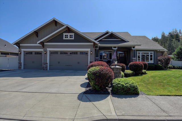 5908 N Bridget Rd, Spokane, WA 99208 - craftsman-style house with an attached garage, driveway, and stone siding
