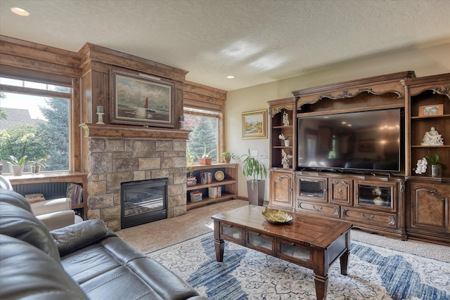 5908 N Bridget Rd, Spokane, WA 99208 - living room featuring light colored carpet, a textured ceiling, a stone fireplace, and recessed lighting
