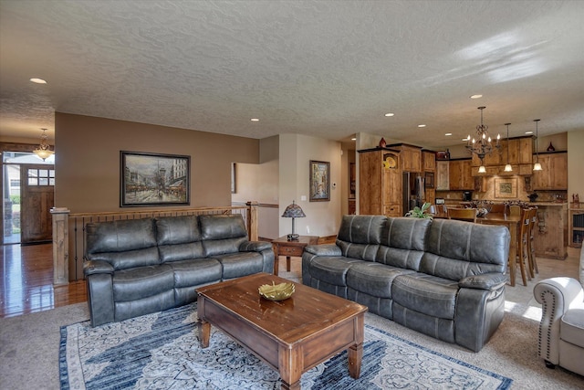 5908 N Bridget Rd, Spokane, WA 99208 - living room featuring a chandelier, recessed lighting, light carpet, and a textured ceiling