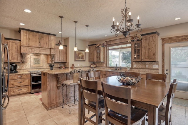 5908 N Bridget Rd, Spokane, WA 99208 - kitchen with range with two ovens, brown cabinetry, decorative backsplash, a textured ceiling, and recessed lighting