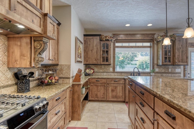 5908 N Bridget Rd, Spokane, WA 99208 - kitchen featuring backsplash, brown cabinetry, light stone counters, glass insert cabinets, and a textured ceiling
