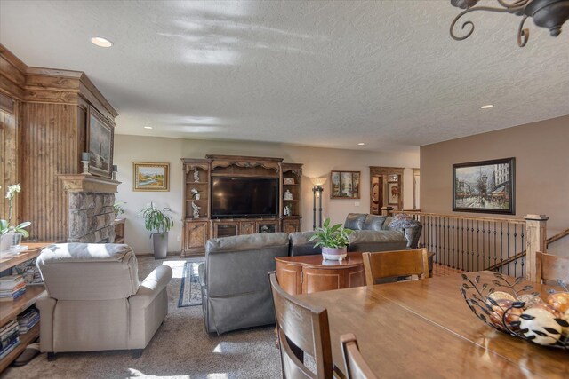 5908 N Bridget Rd, Spokane, WA 99208 - carpeted living area featuring recessed lighting, a textured ceiling, and a fireplace