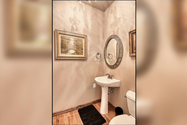 5908 N Bridget Rd, Spokane, WA 99208 - half bathroom featuring toilet and wood finished floors
