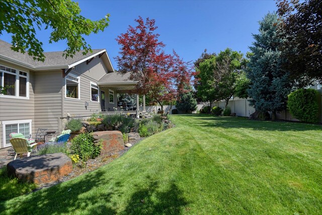 5908 N Bridget Rd, Spokane, WA 99208 - craftsman-style home with a shingled roof, a front lawn, a porch, and stone siding