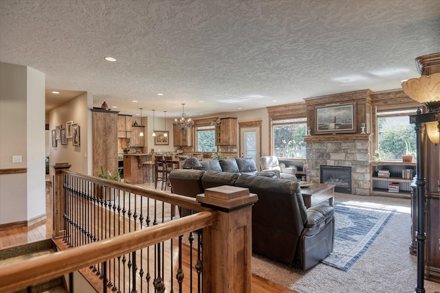 5908 N Bridget Rd, Spokane, WA 99208 - living room featuring a textured ceiling, a chandelier, a fireplace, and recessed lighting