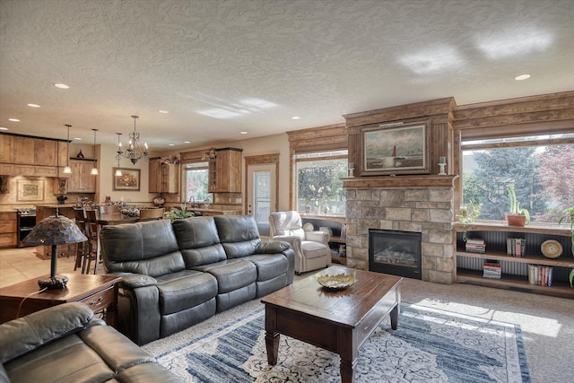 5908 N Bridget Rd, Spokane, WA 99208 - living area featuring a chandelier, recessed lighting, a fireplace, and a textured ceiling