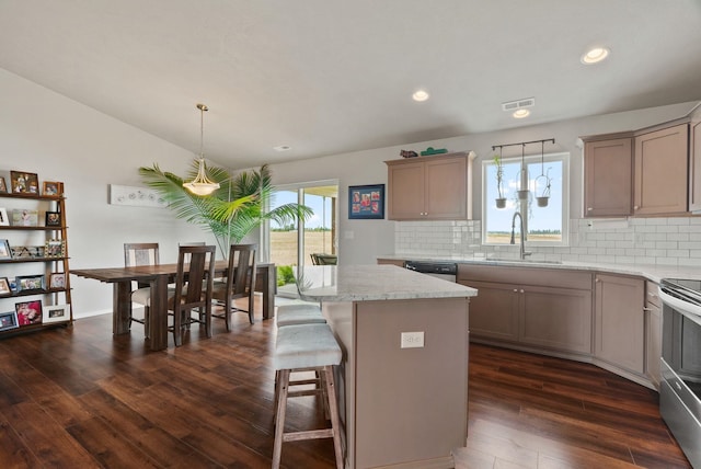 818 S Apple Pl, Spokane, WA 99224 - kitchen with tasteful backsplash, dark wood-style floors, appliances with stainless steel finishes, a kitchen island, and recessed lighting