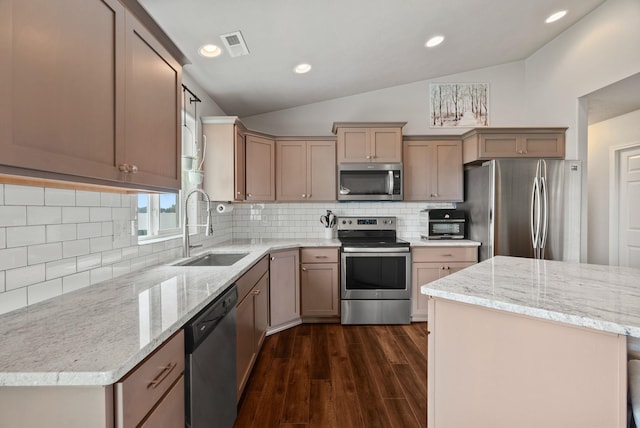 818 S Apple Pl, Spokane, WA 99224 - kitchen featuring stainless steel appliances, lofted ceiling, dark wood-style flooring, light stone countertops, and backsplash