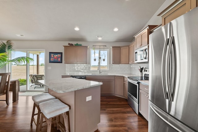 818 S Apple Pl, Spokane, WA 99224 - kitchen featuring stainless steel appliances, healthy amount of natural light, a center island, dark wood-style flooring, and recessed lighting