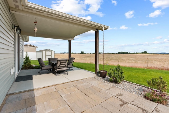 818 S Apple Pl, Spokane, WA 99224 - view of patio / terrace featuring a shed, outdoor dining area, and a view of rural / pastoral area