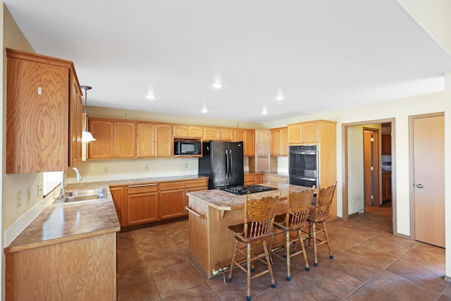 19915 S Ritchey Rd, Cheney, WA 99004 - kitchen featuring black appliances, a breakfast bar, a kitchen island, light countertops, and dark tile patterned floors