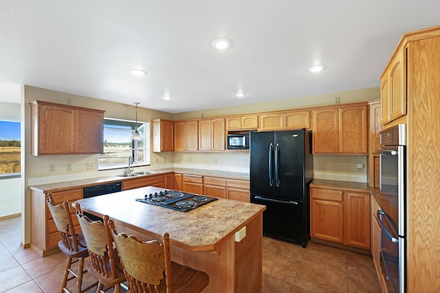 19915 S Ritchey Rd, Cheney, WA 99004 - kitchen featuring black appliances, a kitchen breakfast bar, light tile patterned flooring, light countertops, and recessed lighting