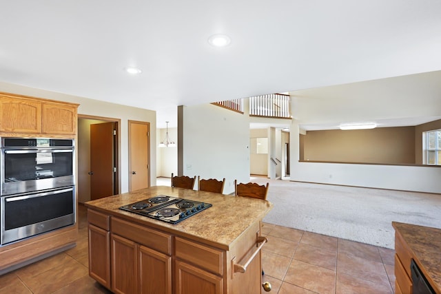 19915 S Ritchey Rd, Cheney, WA 99004 - kitchen with black electric stovetop, double oven, light colored carpet, light tile patterned flooring, and open floor plan