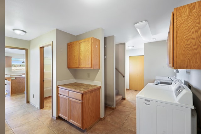 19915 S Ritchey Rd, Cheney, WA 99004 - washroom featuring cabinet space, washer and dryer, and light tile patterned floors