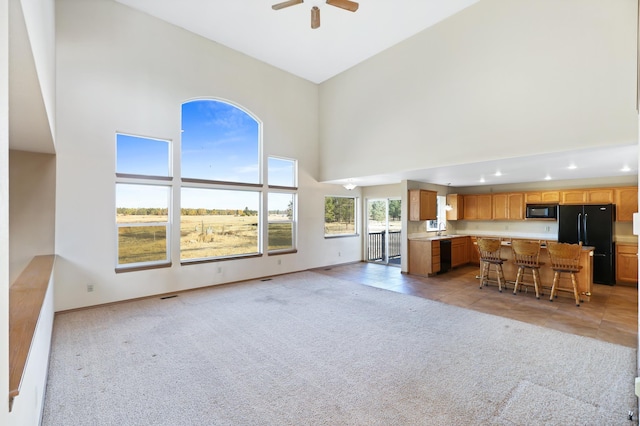 19915 S Ritchey Rd, Cheney, WA 99004 - living room featuring a high ceiling, light carpet, ceiling fan, light tile patterned flooring, and recessed lighting