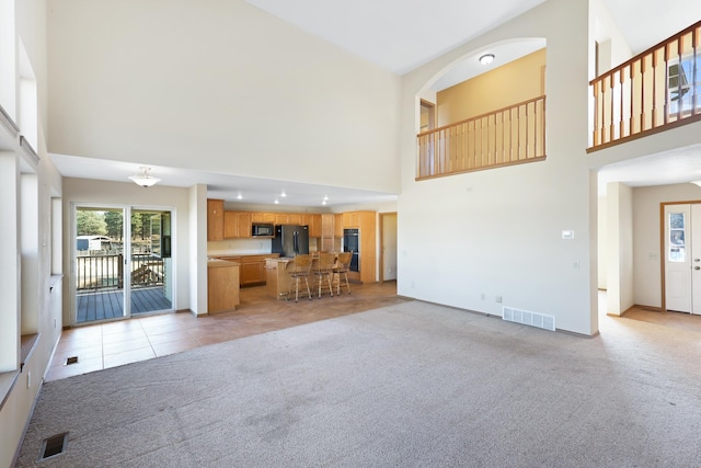 19915 S Ritchey Rd, Cheney, WA 99004 - unfurnished living room featuring a towering ceiling, light carpet, and light tile patterned flooring
