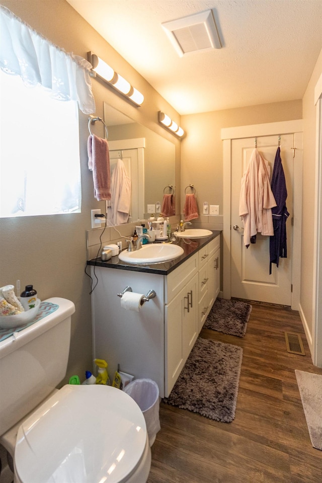 4017 E Hartson Ave, Spokane, WA 99202 - bathroom featuring double vanity and wood finished floors