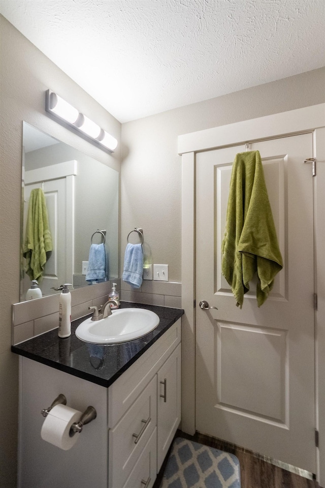 4017 E Hartson Ave, Spokane, WA 99202 - bathroom featuring vanity, wood finished floors, and a textured ceiling