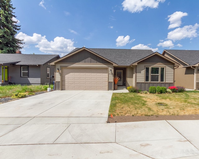 4017 E Hartson Ave, Spokane, WA 99202 - single story home featuring an attached garage, concrete driveway, board and batten siding, a front lawn, and roof with shingles