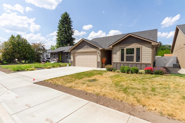 4017 E Hartson Ave, Spokane, WA 99202 - ranch-style home with board and batten siding, an attached garage, concrete driveway, a gate, and a shingled roof