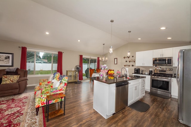 4017 E Hartson Ave, Spokane, WA 99202 - kitchen featuring appliances with stainless steel finishes, open floor plan, dark countertops, lofted ceiling, and dark wood finished floors
