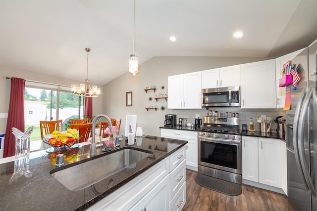 4017 E Hartson Ave, Spokane, WA 99202 - kitchen featuring stainless steel appliances, lofted ceiling, dark wood finished floors, a chandelier, and white cabinets