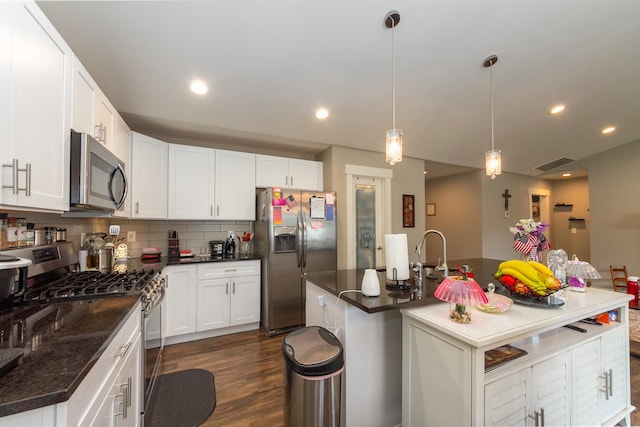 4017 E Hartson Ave, Spokane, WA 99202 - kitchen featuring stainless steel appliances, dark wood-type flooring, tasteful backsplash, white cabinets, and recessed lighting