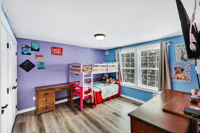 2202 E 50th Ave, Spokane, WA 99223 - bedroom with wood finished floors, an office area, and a textured ceiling