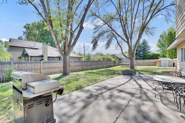 2202 E 50th Ave, Spokane, WA 99223 - fenced backyard featuring a storage shed, a patio area, and area for grilling