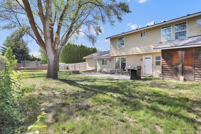 2202 E 50th Ave, Spokane, WA 99223 - rear view of house featuring a trampoline, a shed, a fenced backyard, and a patio area