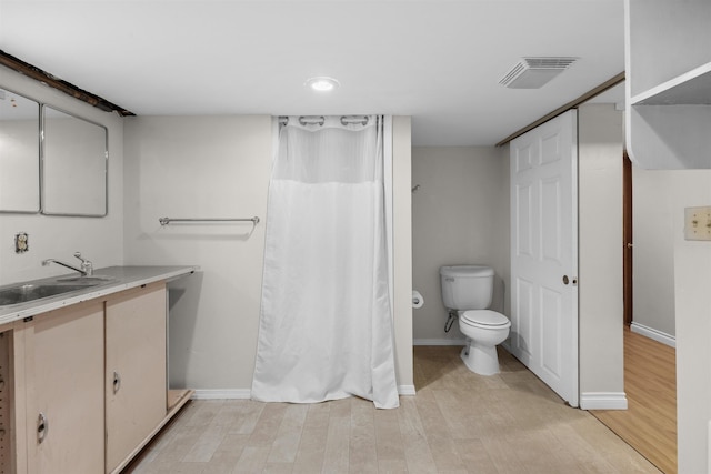 3918 E 8th Ave, Spokane, WA 99202 - bathroom with vanity, wood finished floors, and a shower with shower curtain