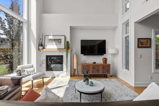 4408 E 23rd Ln, Spokane, WA 99223 - living room featuring a premium fireplace, wood finished floors, and a towering ceiling