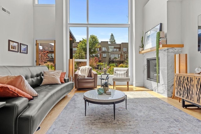 4408 E 23rd Ln, Spokane, WA 99223 - living room with a towering ceiling, a premium fireplace, and wood finished floors