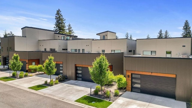 4408 E 23rd Ln, Spokane, WA 99223 - contemporary house with concrete driveway and a garage