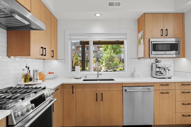 4408 E 23rd Ln, Spokane, WA 99223 - kitchen with appliances with stainless steel finishes, extractor fan, light countertops, backsplash, and recessed lighting