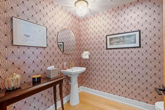4408 E 23rd Ln, Spokane, WA 99223 - bathroom featuring a chandelier and wood finished floors
