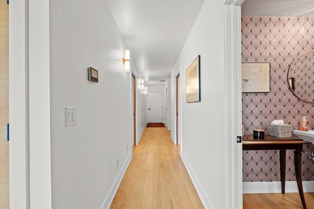 4408 E 23rd Ln, Spokane, WA 99223 - corridor featuring light wood-style flooring, wallpapered walls, and an accent wall
