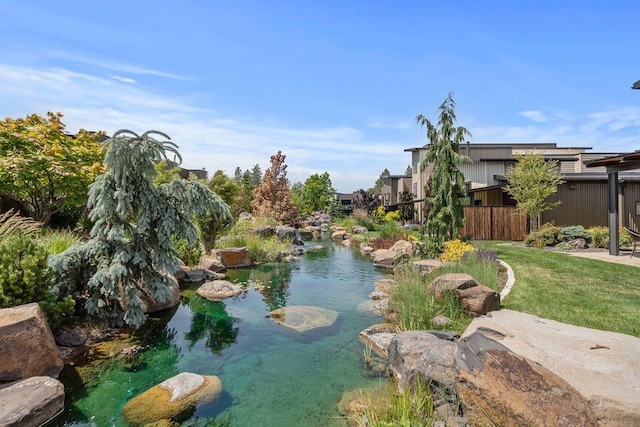 4408 E 23rd Ln, Spokane, WA 99223 - view of home's community with a garden pond and a lawn