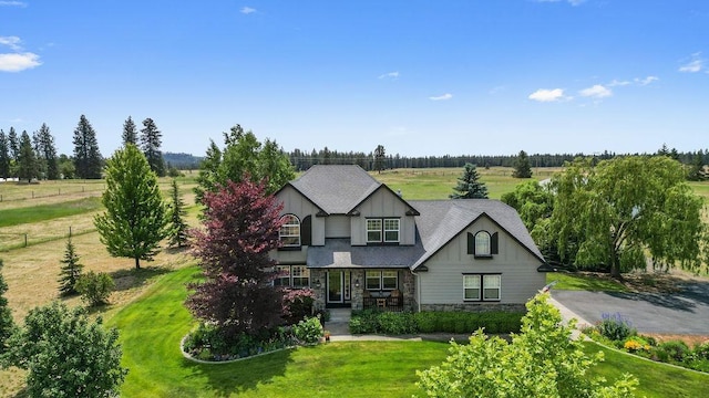 1615 W Country Hunt Ln, Spokane, WA 99224 - craftsman house featuring stone siding, a front lawn, board and batten siding, and a shingled roof
