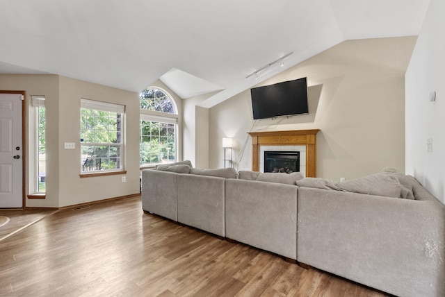 3224 E 42nd Ave, Spokane, WA 99223 - living area with lofted ceiling, rail lighting, wood finished floors, and a tiled fireplace