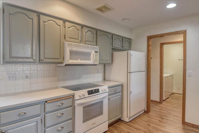 3023 S Winthrop Ln Unit 3023, Spokane, WA 99203 - kitchen with white appliances, independent washer and dryer, gray cabinets, decorative backsplash, and light countertops