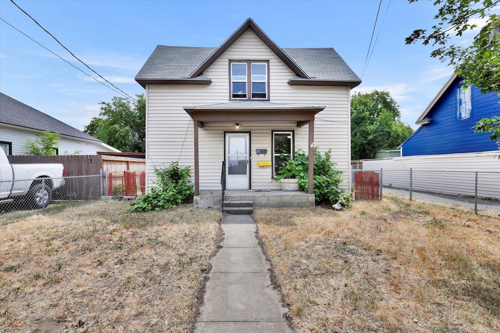 2408 N Standard St, Spokane, WA 99207 - view of front of house with a porch, roof with shingles, and a fenced backyard