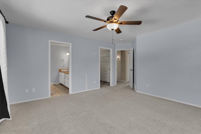2019 S Saint Charles Rd, Veradale, WA 99037 - unfurnished bedroom with light colored carpet, a walk in closet, ensuite bath, and ceiling fan