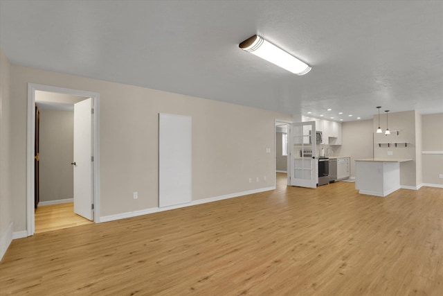 2019 S Saint Charles Rd, Veradale, WA 99037 - unfurnished living room with light wood finished floors and baseboards
