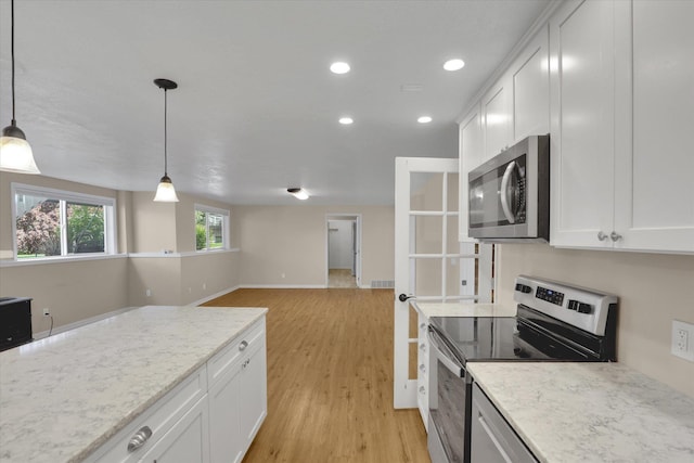 2019 S Saint Charles Rd, Veradale, WA 99037 - kitchen featuring appliances with stainless steel finishes, white cabinets, light wood finished floors, pendant lighting, and recessed lighting