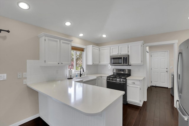 2019 S Saint Charles Rd, Veradale, WA 99037 - kitchen with appliances with stainless steel finishes, a peninsula, light countertops, white cabinetry, and recessed lighting