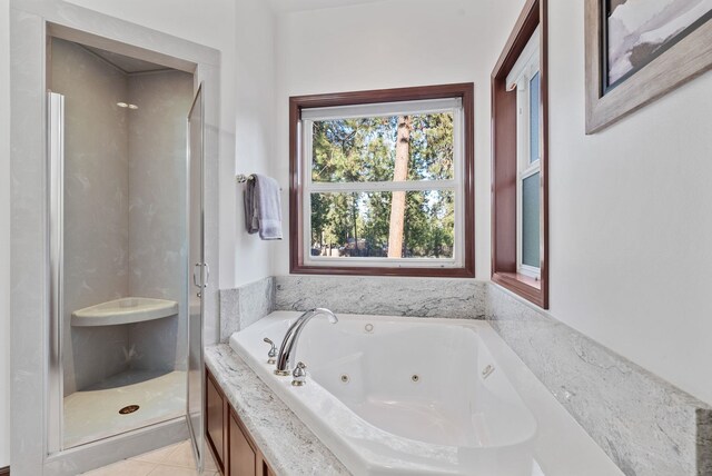 4045 Maple St, Loon Lake, WA 99148 - full bathroom featuring a stall shower, a jetted tub, and tile patterned flooring