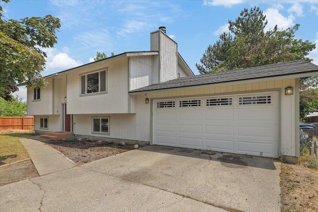 1707 S Early Dawn Dr, Spokane Valley, WA 99037 - raised ranch with driveway, a chimney, and an attached garage