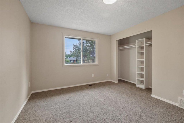 1707 S Early Dawn Dr, Spokane Valley, WA 99037 - unfurnished bedroom featuring carpet, a textured ceiling, and a closet