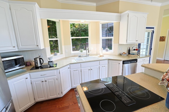 16303 S Cheney-Spokane Rd, Cheney, WA 99004 - kitchen with stainless steel appliances, white cabinets, tasteful backsplash, crown molding, and light countertops